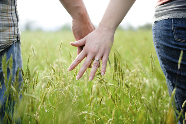 the happy couple holding hands in field - wedding photo by top Portland, Oregon wedding photographer Aaron Courter